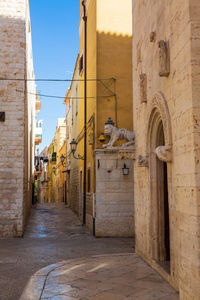 View of alley amidst buildings in city