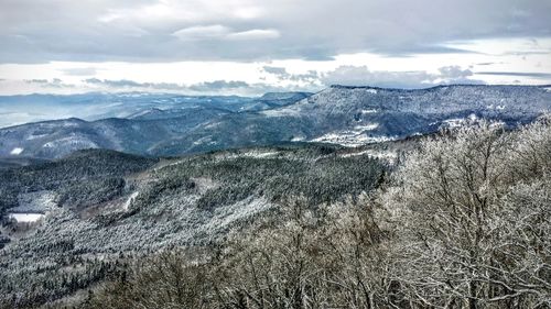 Scenic view of mountains against cloudy sky