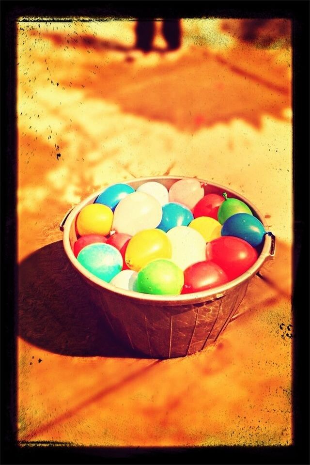 transfer print, multi colored, sand, beach, sport, auto post production filter, ball, childhood, still life, toy, shadow, high angle view, sunlight, colorful, close-up, day, single object, no people, balloon, absence