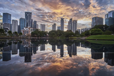 View of skyscrapers against cloudy sky