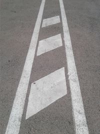 High angle view of arrow symbol on road