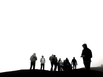 Rear view of silhouette people standing against clear sky