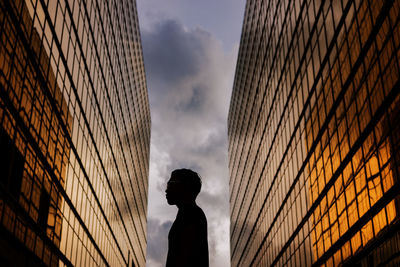 Low angle view of silhouette buildings against sky during sunset