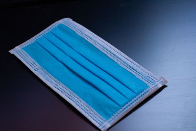 High angle view of blue book on table against black background