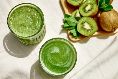 Green smoothie with kiwi fruit in the glasses. healthy organic drink. nutrition and alkaline diet. 