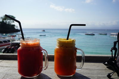 Smoothie in jars against sea