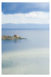 Scenic view of sea and buildings against sky