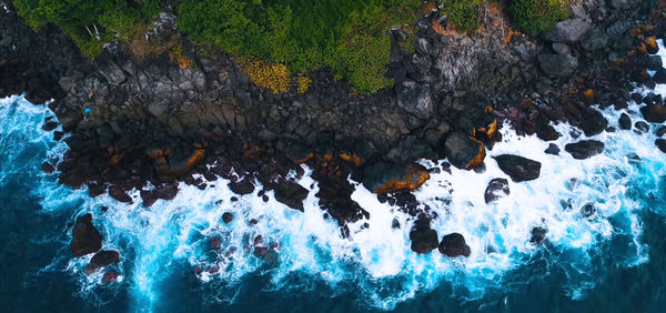 High angle view of rocks in sea