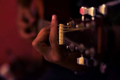 Close-up of man playing guitar