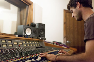 Audio engineer working at mixing board