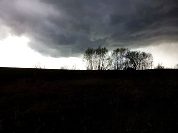 Low angle view of silhouette field against sky