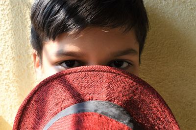 Close-up portrait of young man covering face