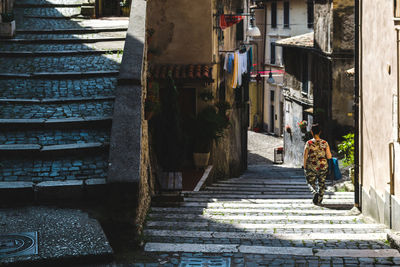 Rear view of woman walking on staircase