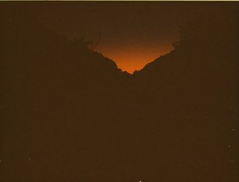 Scenic view of silhouette mountain against sky during sunset