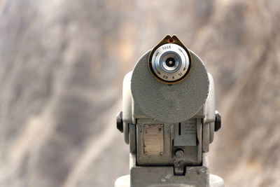 Close-up of coin-operated binoculars against blurred background