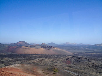 Scenic view of desert against clear blue sky