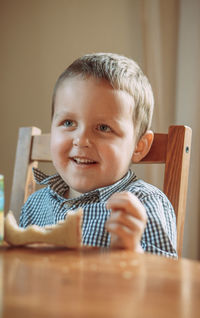 Portrait of boy sitting on table