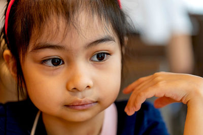 Close-up of cute girl looking away