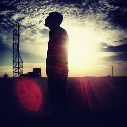 Silhouette man standing against sky during sunset