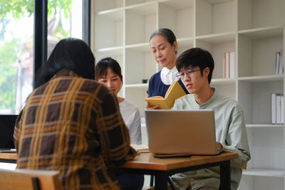 Young woman using laptop while sitting at home