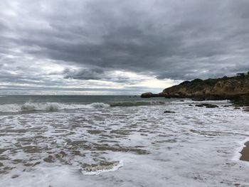 Scenic view of sea against cloudy sky