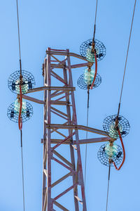 Low angle view of ferris wheel against clear blue sky