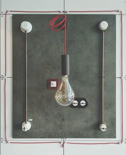 High angle view of electric lamp hanging on wall