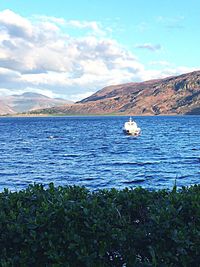 Scenic view of lake against cloudy sky