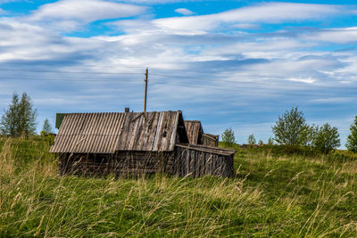 Built structure on field against sky