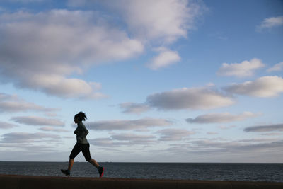 Woman running back lit silhouette