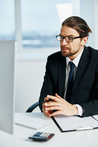 Young man using mobile phone on table