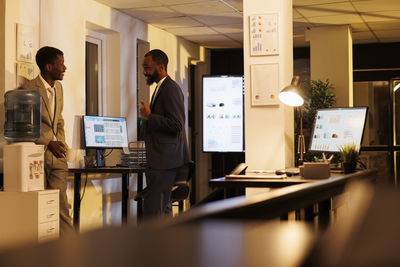 Side view of business colleagues working in office