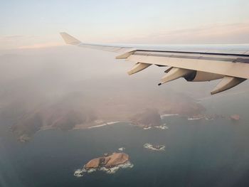 Aerial view of airplane flying in sky