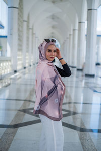 Portrait of woman standing in building