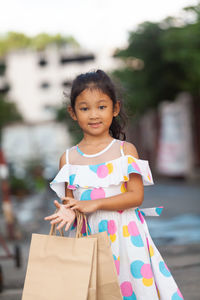 Portrait of girl standing against blurred background