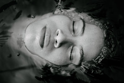 Close-up of young woman in water