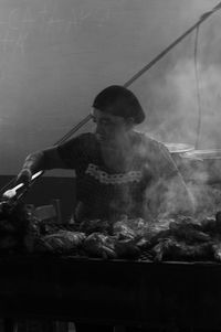 Man working on barbecue grill at market