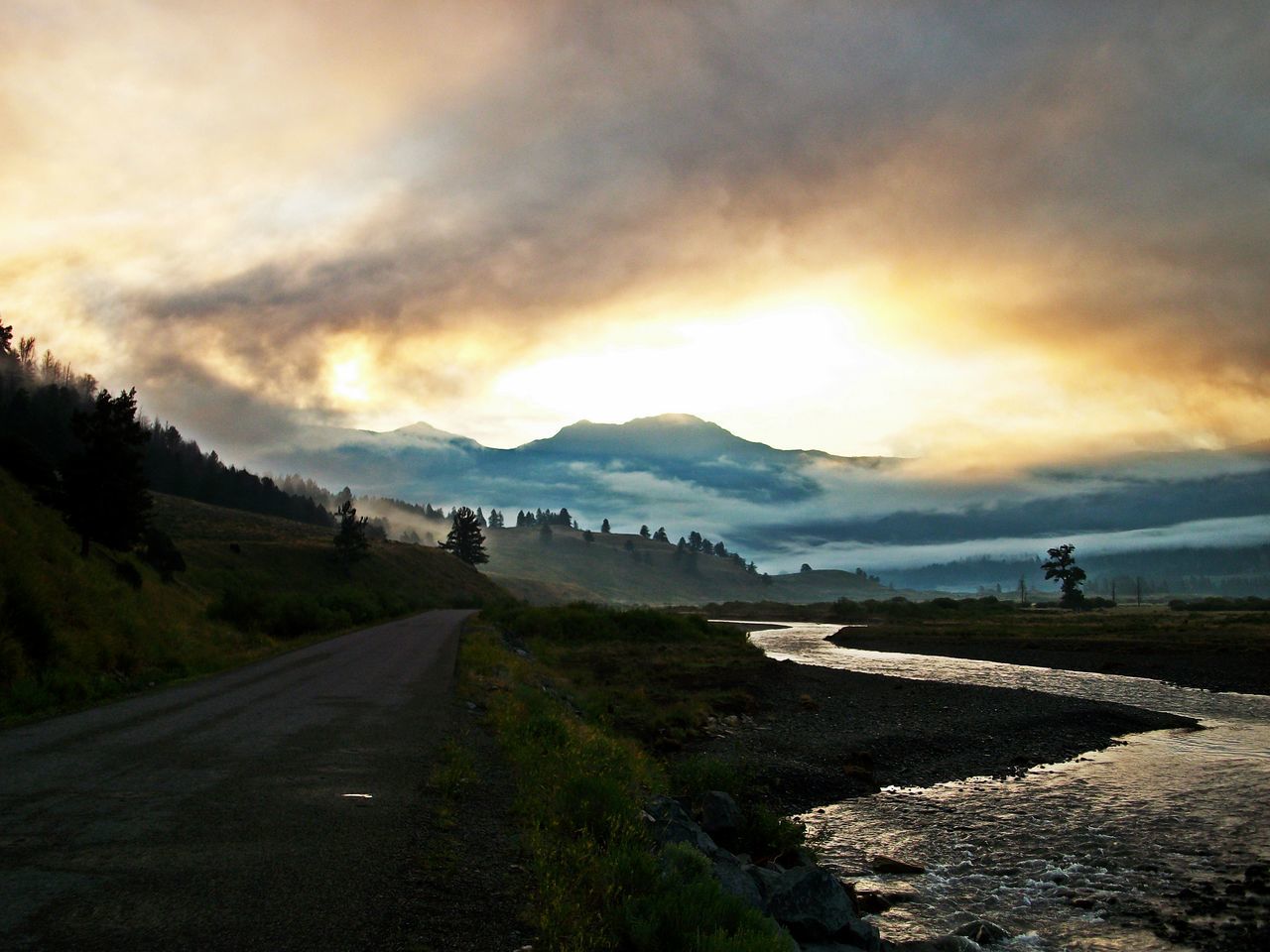 ROAD LEADING TOWARDS MOUNTAIN AGAINST SKY DURING SUNSET