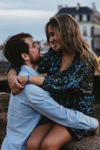 Beautiful young woman sitting outdoors