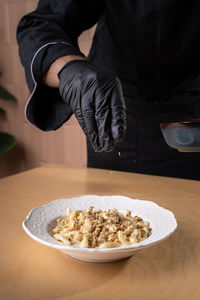 Midsection of man preparing food