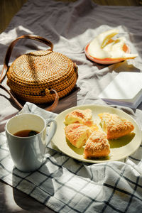Morning breakfast in bed on blanket with tea, fruit and pie. summer mood inspiration.