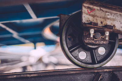 Close-up of rollercoaster wheel at amusement park