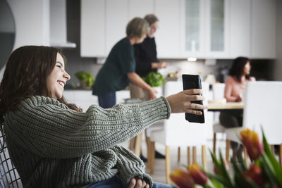 Smiling teenager girl showing phone