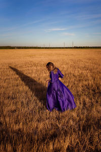 Rear view of woman on field