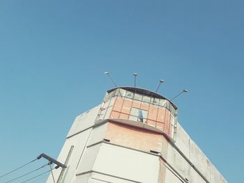 Low angle view of bird building against clear blue sky