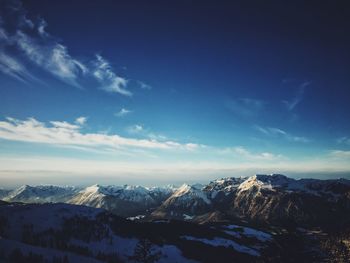 Scenic view of snowcapped mountain against blue sky