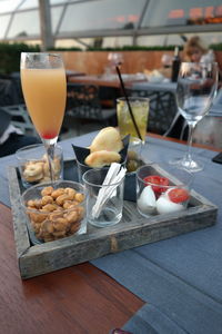Bellini drink served with snacks in tray at restaurant