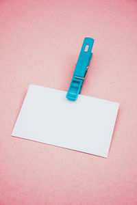 High angle view of blank paper on pink background