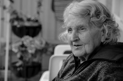 Close-up portrait of woman sitting at home