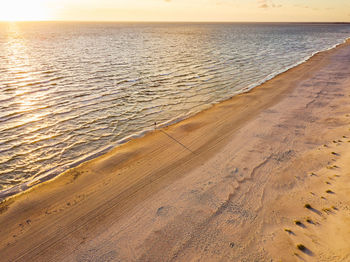 Scenic view of beach against sky during sunset